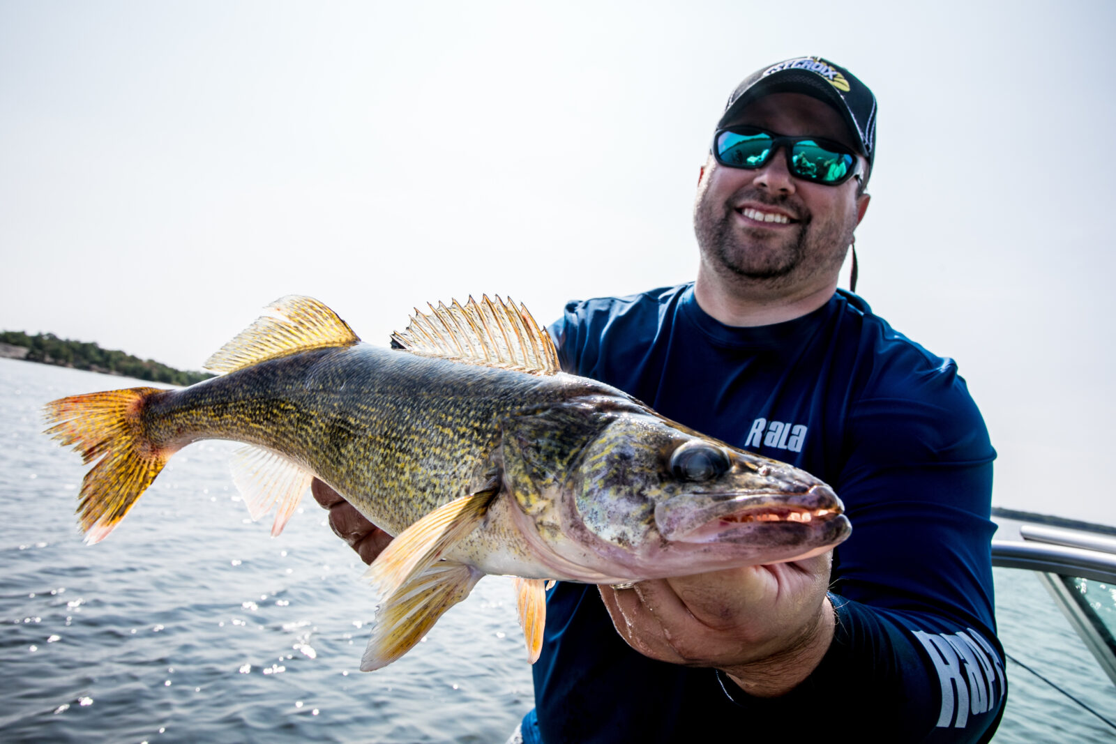angler, joel nelson, holding a fish he caught on his boat