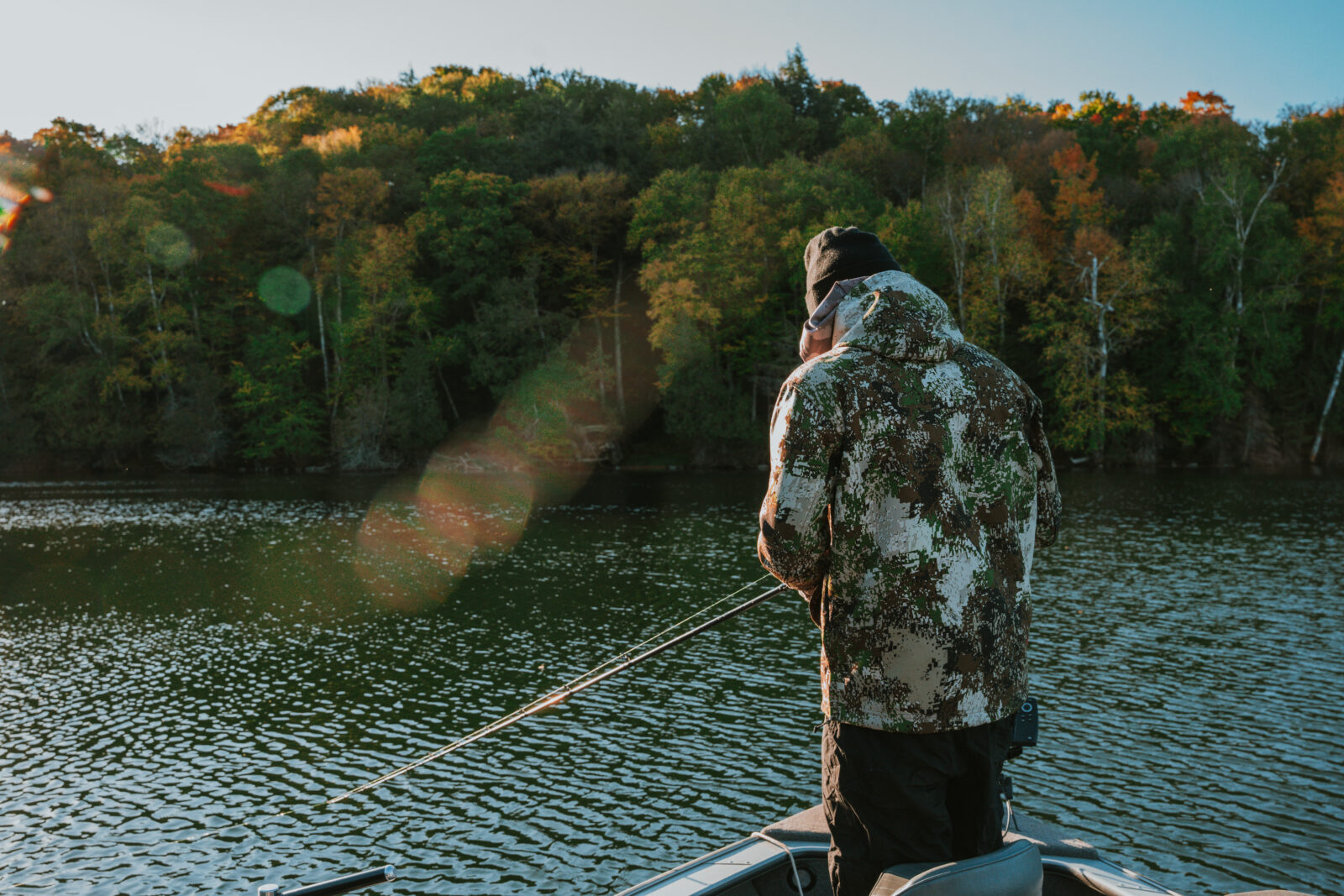 an angler in a boat fishing in a lake