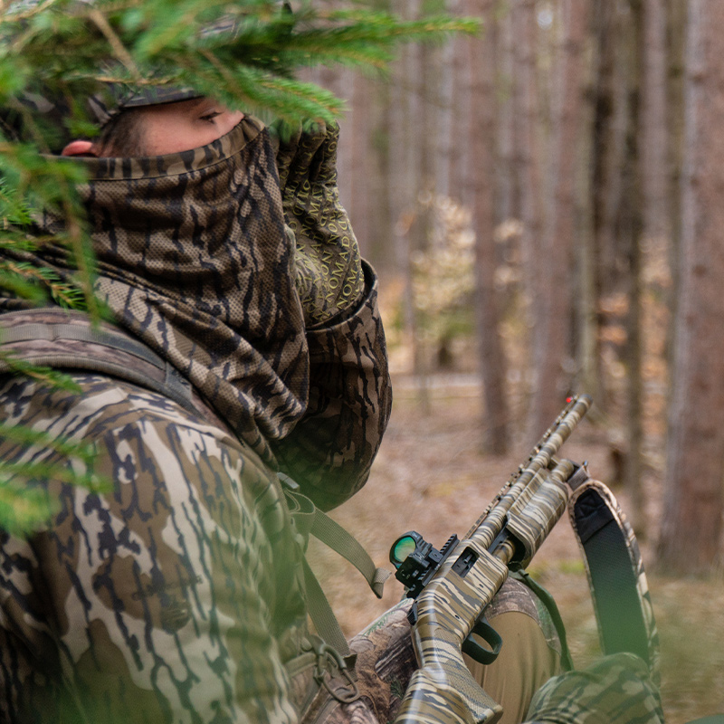 A turkey hunter holds a shotgun